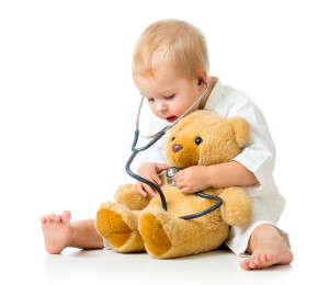 Adorable girl with clothes of doctor isolated on white